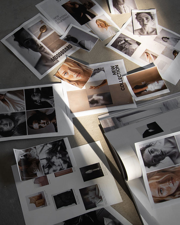 Collection of fashion magazines with model images on a textured surface