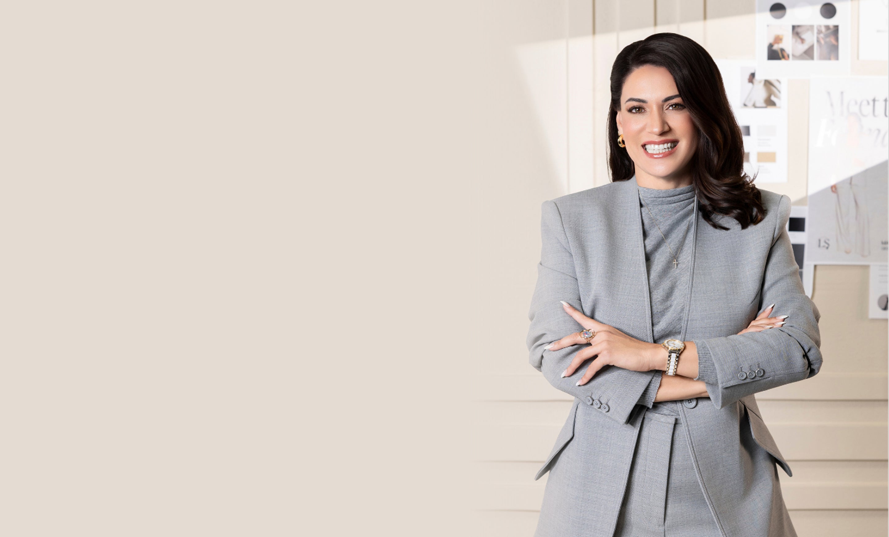 Woman in a gray blazer standing in an office setting