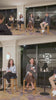 Four people sit on stools during a panel discussion in a hotel lounge, with one woman speaking into a microphone while others listen.
